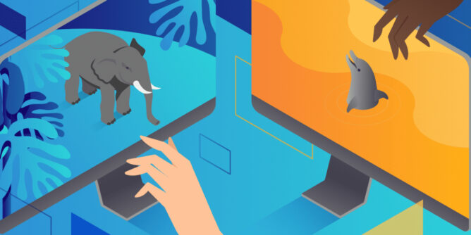 ruka izme]u dva monitora / na jednom je slon a na drugom delfin